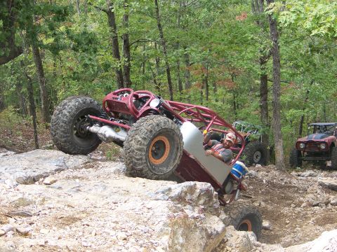 2001 Dodge 1500 - A custom buggy navigates a rocky trail with other off-road vehicles in the background.