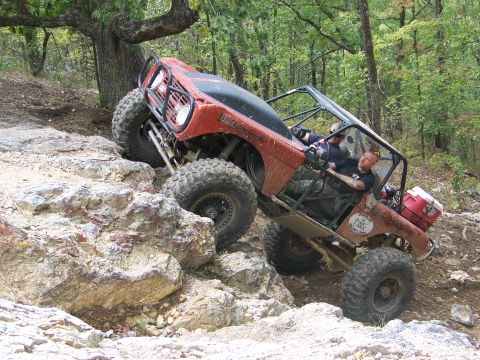 2001 Dodge 1500 - This heavily modified off-road vehicle navigates a challenging rocky incline, its off-road capabilities.