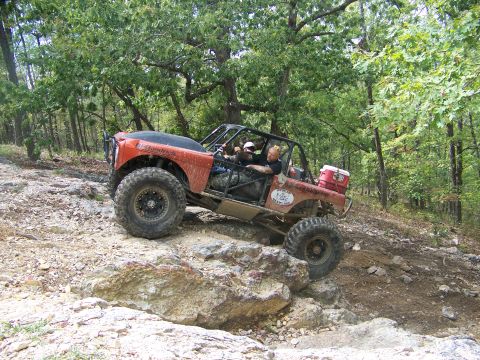 2001 Dodge 1500 - A custom-built buggy navigates a challenging rocky trail in a forest setting.