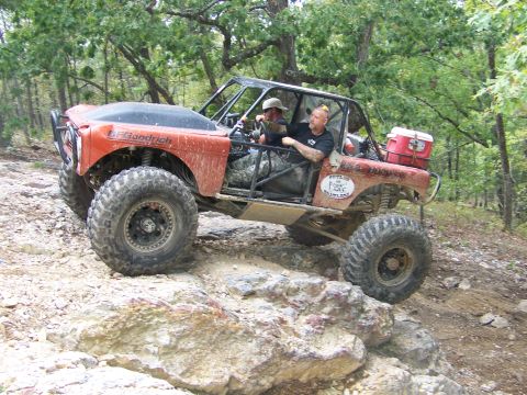 2001 Dodge 1500 - Modified off-road vehicle navigates a challenging rocky trail with two occupants.