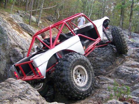 2001 Dodge 1500 - Custom buggy navigates a challenging rocky terrain with two people inside.