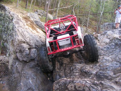 2001 Dodge 1500 - A heavily modified off-road buggy navigates a challenging rocky terrain.