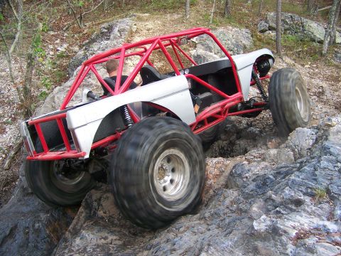2001 Dodge 1500 - Custom off-road buggy navigates a rocky trail with its large tires.