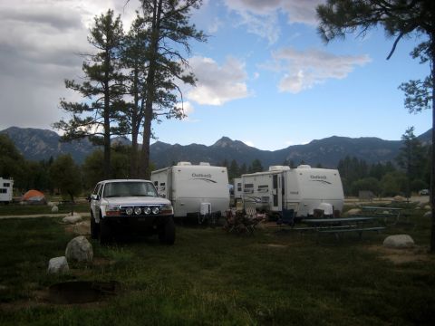 1996 Ford Bronco - 1996 Ford Bronco at a campsite with travel trailers and mountain scenery.