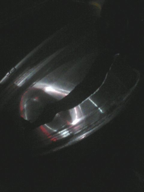 1988 Ford Bronco - A close-up view of a chrome exhaust pipe, reflecting light in the darkness.