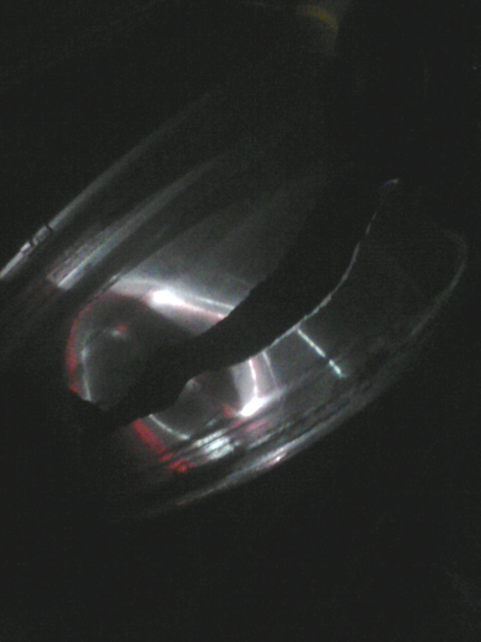 Chrome exhaust pipe with reflections, dark background