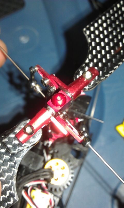 1992 Ford Ranger - This is a close-up view of a red metal rotor head assembly, likely from a model aircraft or drone.