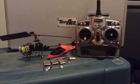 1992 Ford Ranger - A collection of remote control helicopters and their transmitter are laid out on a surface.