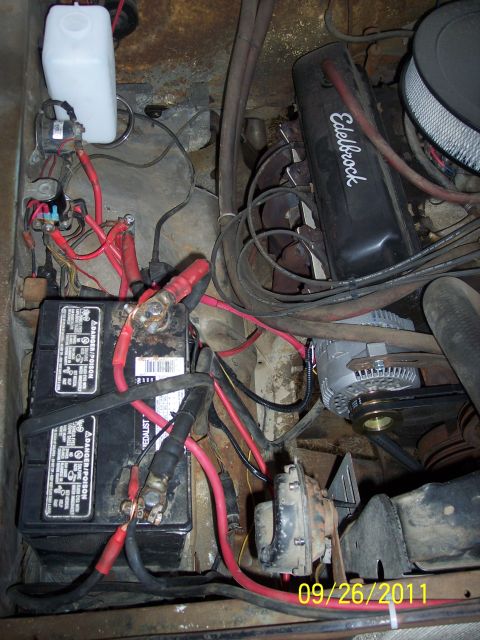 1973 Ford F-250 - Close-up view of a vehicle's engine bay, showing battery and electrical components.