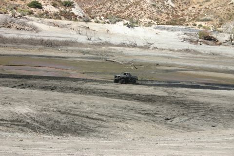 1991 Ford Bronco - A 1980s Ford Bronco navigates a barren, dusty landscape.