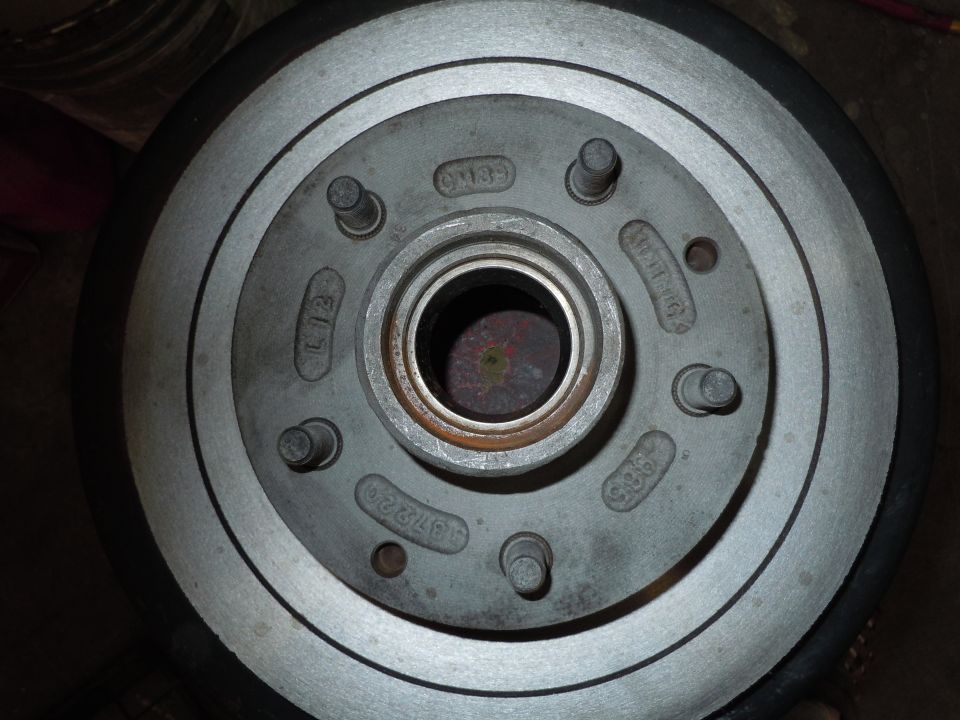 Car brake rotor with stamped part numbers like L12 and 147220