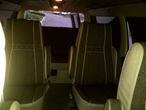 1979 Ford E250 - Van interior with two rows of captain's chairs visible, looking towards the front.