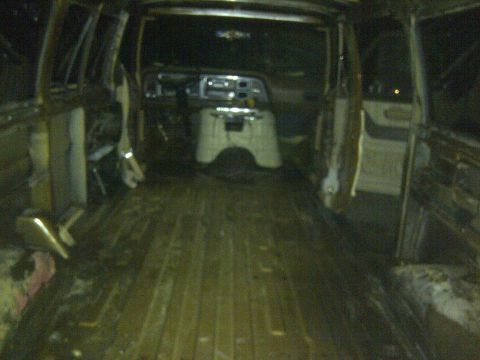 1979 Ford E250 - The cargo area of the van is empty, showing the wooden floor and the dashboard area.
