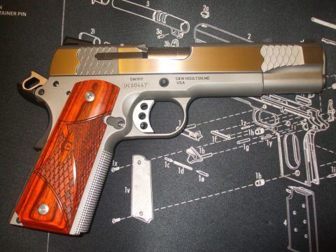 1979 Ford Bronco - A pistol with intricate detailing sits on a mat displaying its disassembled parts.