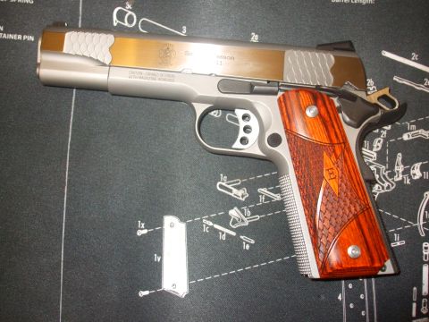 1979 Ford Bronco - A pistol with a two-tone slide and ornate wood grips rests on a mat displaying firearm schematics.