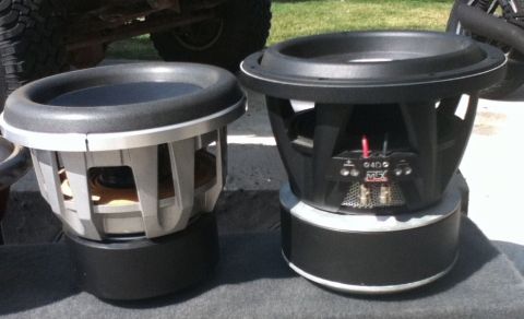 2006 Ford E350 - Two car subwoofers are displayed outdoors, with a portion of a vehicle visible in the background.