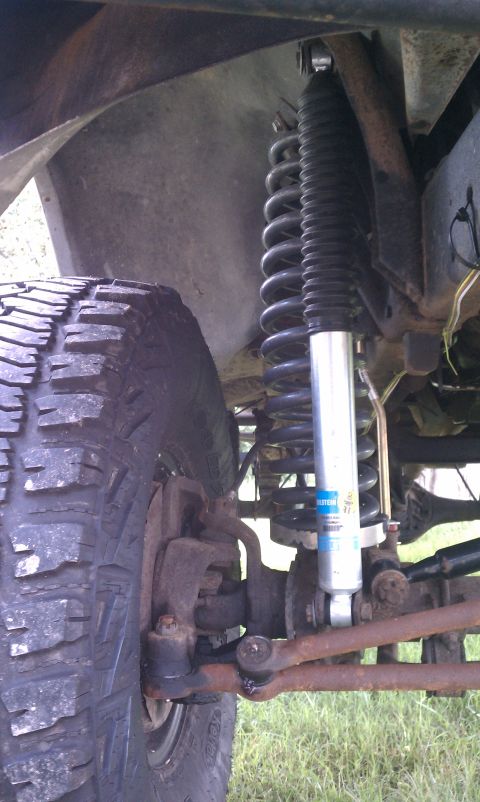 1979 Ford Bronco - This image shows the suspension components of an off-road vehicle, including a tire and shock absorber.