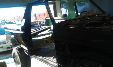 1995 Ford Bronco - This 1995 Ford Bronco is in a workshop, with its doors open and interior exposed.