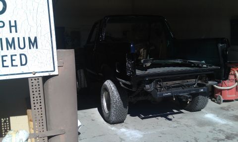 1995 Ford Bronco - A black truck is shown from the rear with its bed removed and bumper missing.