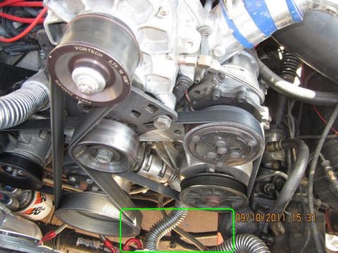 1996 Ford Bronco - Close-up of a Vortech supercharger pulley and belt system in an engine bay.