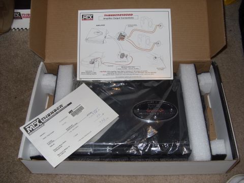 2006 Ford E350 - An audio amplifier is shown inside its packaging with accompanying documentation.