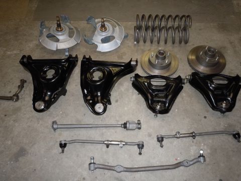 1973 Pontiac Trans Am - Various automotive suspension and steering parts are displayed on a gray surface.