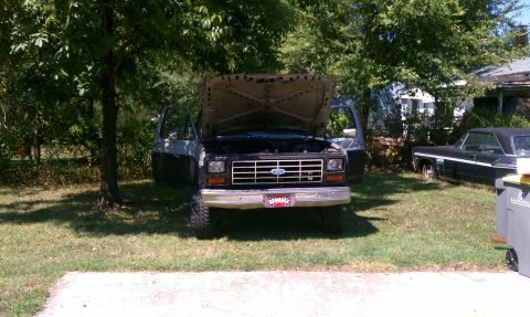 1985 Ford Bronco - This Ford Bronco appears to be from the early 1980s, with its hood and doors open in a grassy yard.