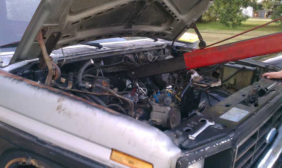 1985 Ford Bronco engine bay with engine hoist and tools