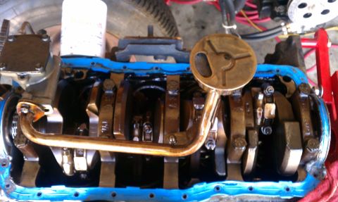 1985 Ford Bronco - Close-up view of an engine's internal components, including the crankshaft and oil pickup assembly.