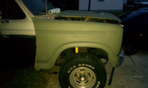 1985 Ford Bronco - Ford Bronco fender and door detail, hood is open.