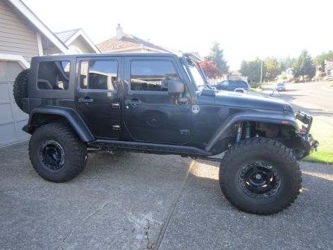 2008 Jeep Wrangler - This modified Jeep Wrangler features an aftermarket suspension and large off-road tires, suggesting a model year prior to 2007.