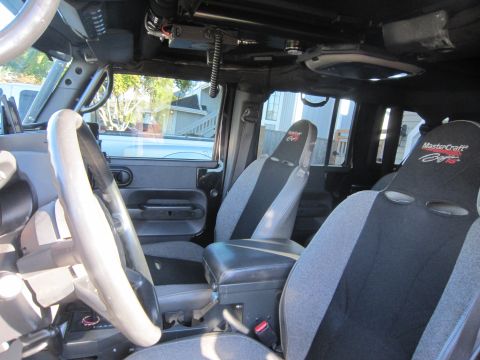 2008 Jeep Wrangler - Interior view of a modified Jeep Wrangler, showing racing seats and aftermarket accessories.