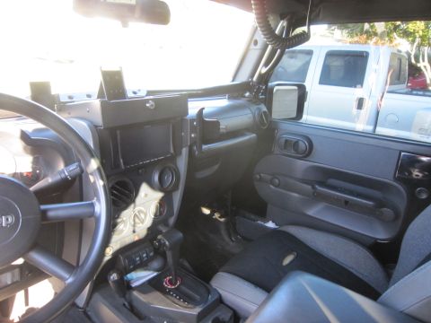 2008 Jeep Wrangler - The interior of a 2007 Jeep Wrangler is captured, highlighting the dashboard, steering wheel, and passenger seat.