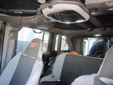 2008 Jeep Wrangler - Interior of a Jeep Wrangler, likely a JK generation, with aftermarket seats and a spare tire mounted at the rear.