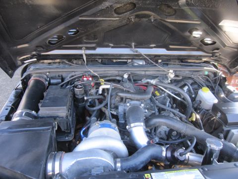 2008 Jeep Wrangler - This Jeep Wrangler's engine bay features a prominent turbocharger and modified intake system.