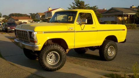 1978 Ford Bronco - This bright yellow 1978 Ford Bronco is captured from a three-quarter front view, its lifted suspension and tires.