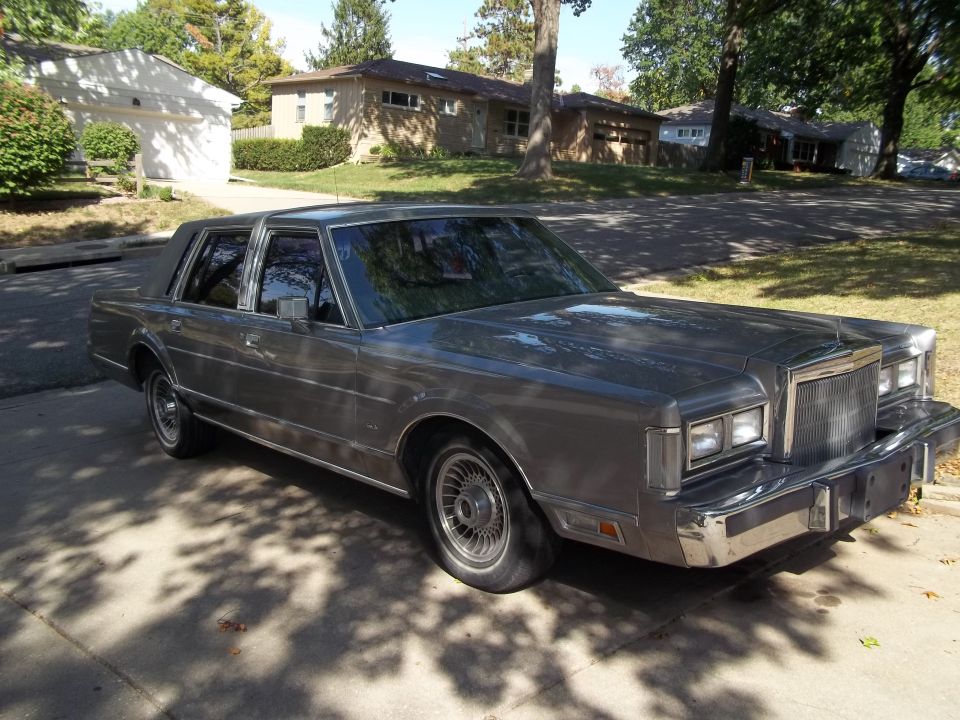 Gray 1988 Lincoln Town Car parked on a driveway, front 3/4 view