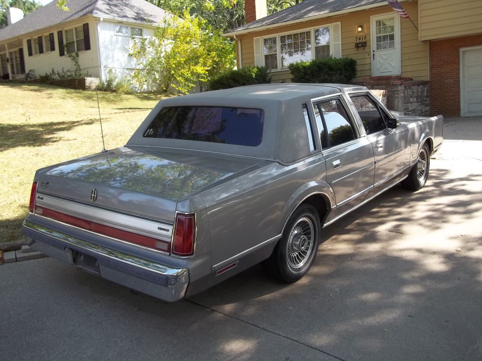 Gray 1988 Lincoln Town Car parked in a driveway, rear-left quarter view