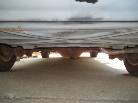 1988 Lincoln Town Car - Underside view of a car, focusing on the rear differential and exhaust system.