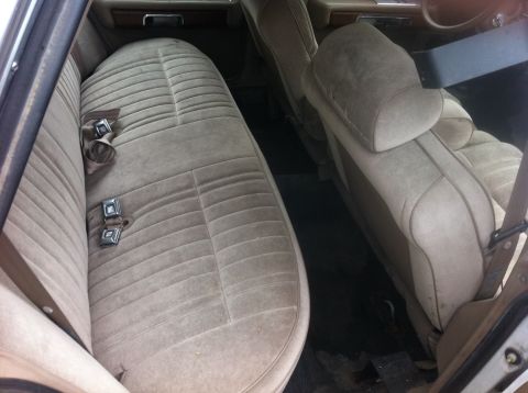 1991 Ford Crown Victoria LTD - Interior view of a car with tan velour seats and seatbelts visible.