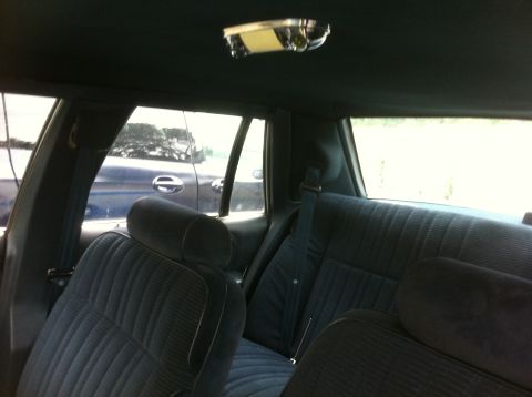 1991 Ford Crown Victoria LTD - The interior of a car is shown, with a view of another vehicle through the rear window.