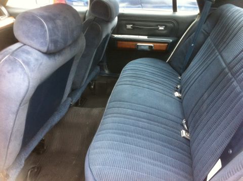 1991 Ford Crown Victoria LTD - The interior of a 1991 Ford Crown Victoria LTD, showing the blue fabric seats and door panel.