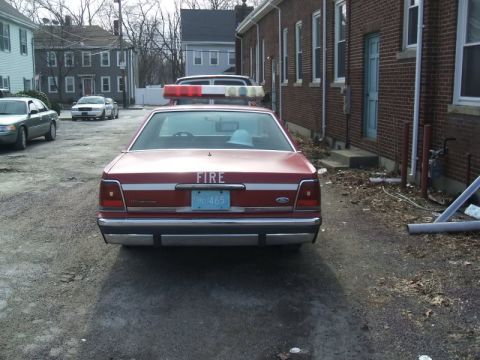 1991 Ford Crown Victoria LTD - This 1991 Ford Crown Victoria LTD police car is seen from the rear, equipped with a light bar and marked with the word FIRE.