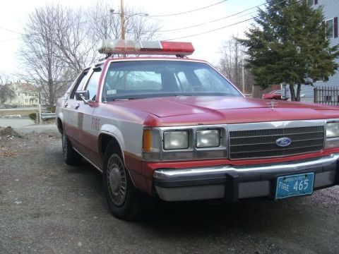 1991 Ford Crown Victoria LTD - This Ford Crown Victoria police car has a light bar and 'FIRE' markings on the side.