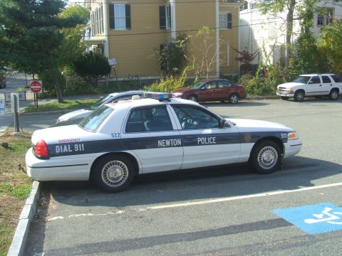 1991 Ford Crown Victoria LTD - A white 1991 Ford Crown Victoria LTD police car is parked next to other vehicles.