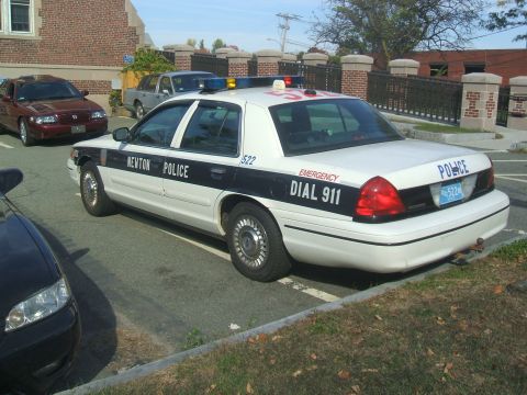 1991 Ford Crown Victoria LTD - A 1991 Ford Crown Victoria LTD police car is parked next to another vehicle.