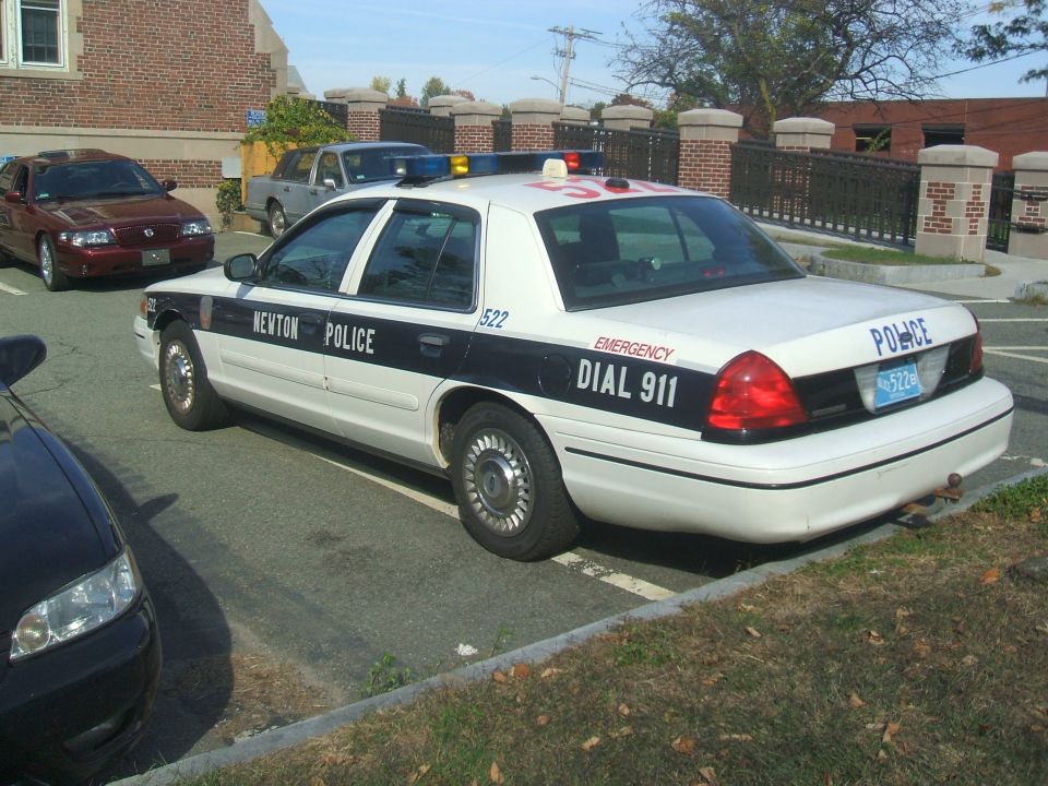 1991 Ford Crown Victoria LTD police car, white with black stripe, parked on asphalt
