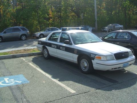 1991 Ford Crown Victoria LTD - Newton Police car, likely a Ford Crown Victoria, parked in a handicapped space.