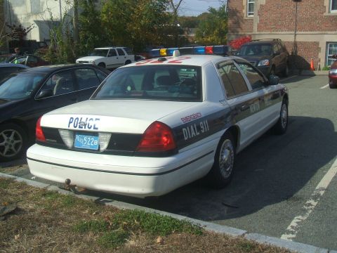 1991 Ford Crown Victoria LTD - A 1991 Ford Crown Victoria LTD police car is parked in a lot, showing its rear and side details.