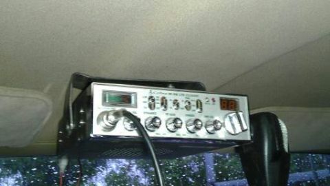 1989 Ford Bronco - Overhead view of a Cobra 29 LTD Classic CB radio with a microphone attached.